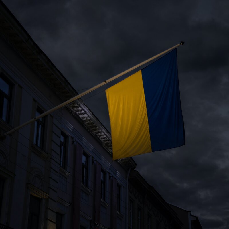 Ukraine Fahne vor dunklem Hintergrund | © Foto: Artem Kniaz | Unsplash