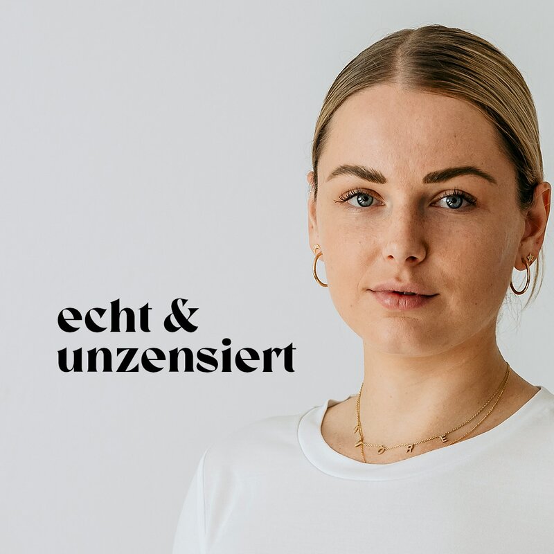 Hebamme Eva Placzek steht vor einer weißen Wand und lächelt. | © Eva Placzek