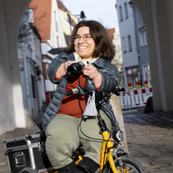 Andrea Schöne mit Kamera unter einem Torbogen | © Kurt Steinhausen